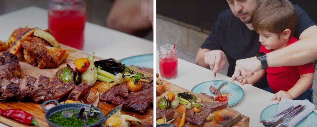 Tábua de churrasco com carne e legumes e pai almoçando com filho. 