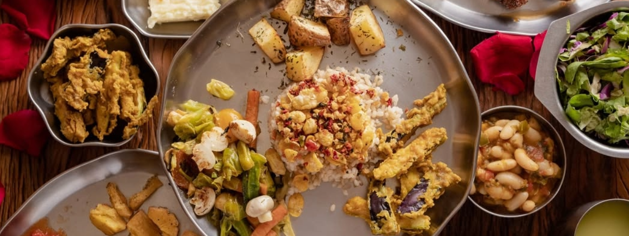 Mesa com pratos de comidas vegetarianas, demonstrando a riqueza de sabores e cores da gastronomia vegetariana