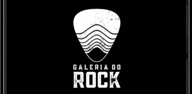 Logotipo da Galeria do Rock sobre fundo preto. A marca apresenta uma palheta de guitarra estilizada em branco, com linhas curvas e efeito desgastado, acima da inscrição "Galeria do Rock" em letras brancas.