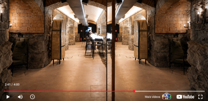 Vista do interior do Bar dos Arcos, instalado nos antigos alicerces do Theatro Municipal de São Paulo. O ambiente reúne paredes e arcos de pedra, iluminação aconchegante, mobiliário contemporâneo e um balcão central, combinando a arquitetura histórica com um espaço dedicado à gastronomia e à coquetelaria.